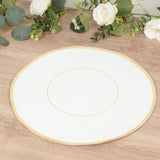 Elegant white plate with gold rim on wooden table.