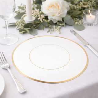 White plate with gold rim on elegant dining table setting