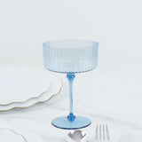 Blue ribbed dessert glass on a white background