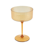 Amber ribbed glass dessert cup on a white background. #whtbkgd