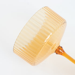 Amber glass dessert bowl with ribbed design.