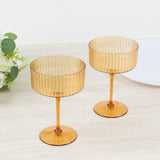 Amber ribbed glass dessert cups on a wooden table.