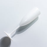 White champagne flute on a plain background