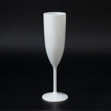 White champagne flute on a black background.
