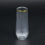 Elegant ribbed glass vase with a gold rim.