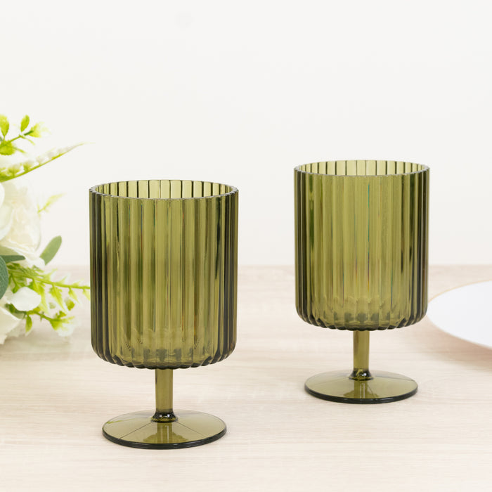 Green ribbed glass cups on a wooden table.
