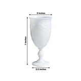 White decorative goblet with floral design, 7 inches tall, 3 inches wide, 2.5 inches base.