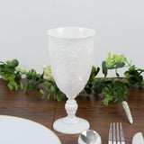 Elegant white decorative glass on a dining table with greenery accents.