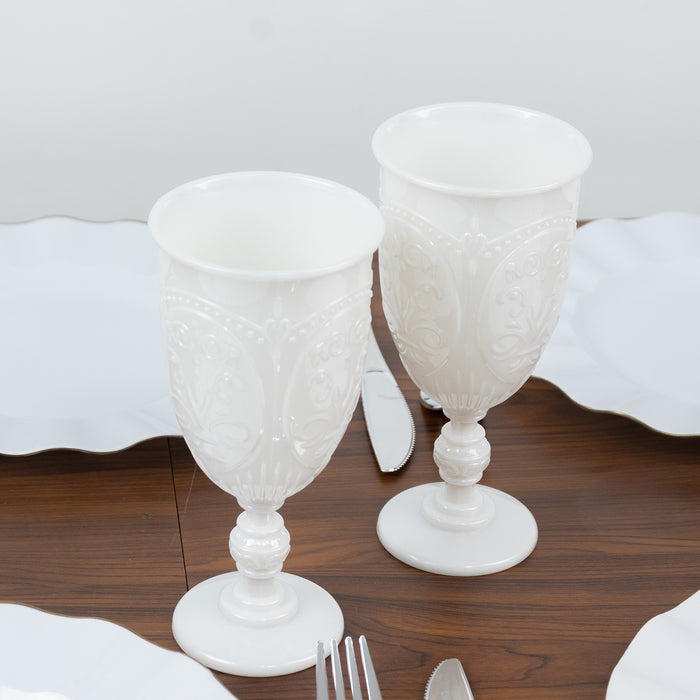 Elegant white decorative goblets on a wooden table.