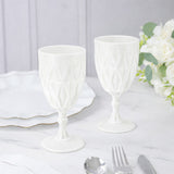 Elegant white textured goblets on a marble table setting.