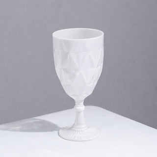 White geometric patterned glass goblet on a plain background.