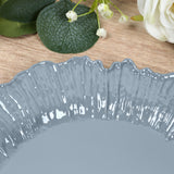 Gray decorative plate with a textured rim on a wooden surface.