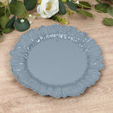 Gray decorative plate with a scalloped edge on a wooden surface.