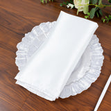 White napkin neatly folded on a decorative plate.