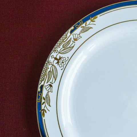 White plate with blue and gold floral rim on burgundy background