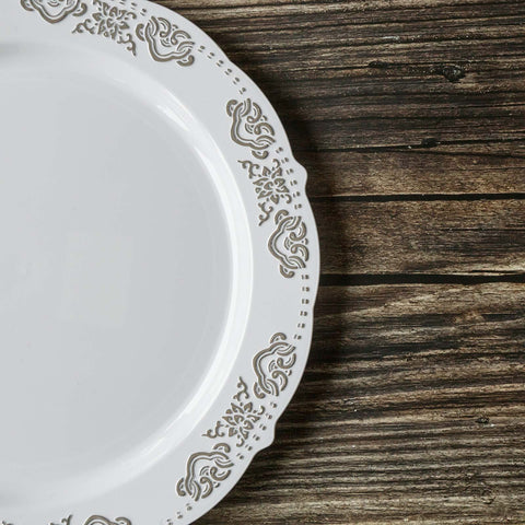 White plate with yellow rim and gold flatware