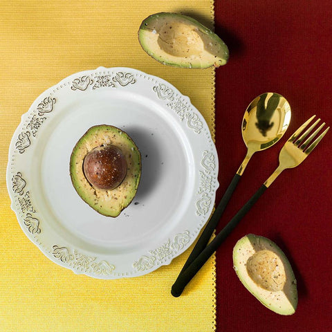 White plate with silver decorative rim on wood background