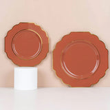 Scalloped edge decorative plates in terracotta with gold trim