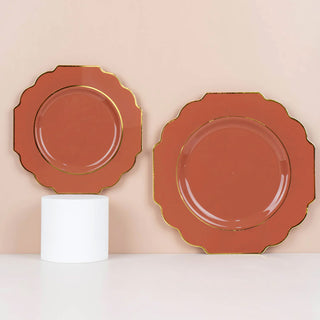Scalloped edge decorative plates in terracotta with gold trim