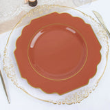 Elegant decorative plate with gold trim on a white table setting.