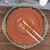 Elegant dinnerware set with decorative plates and gold-accented utensils.
