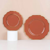 Two elegant scalloped plates with gold trim on a neutral background.
