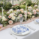 Elegant table setting with floral arrangement and decorative plates.