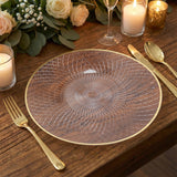 Elegant clear glass plate with gold trim on a wooden table setting.