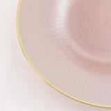 Pink decorative plate with gold rim and textured design.