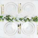 Elegant dining set with gold-accented plates and cutlery on a marble table.