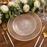Elegant clear charger plate with gold trim on a wooden table setting.