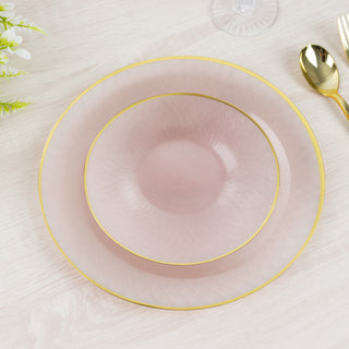 Elegant pink plates with gold trim on a light wooden table.