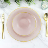 Elegant pink plates with gold trim, styled on a marble table setting.