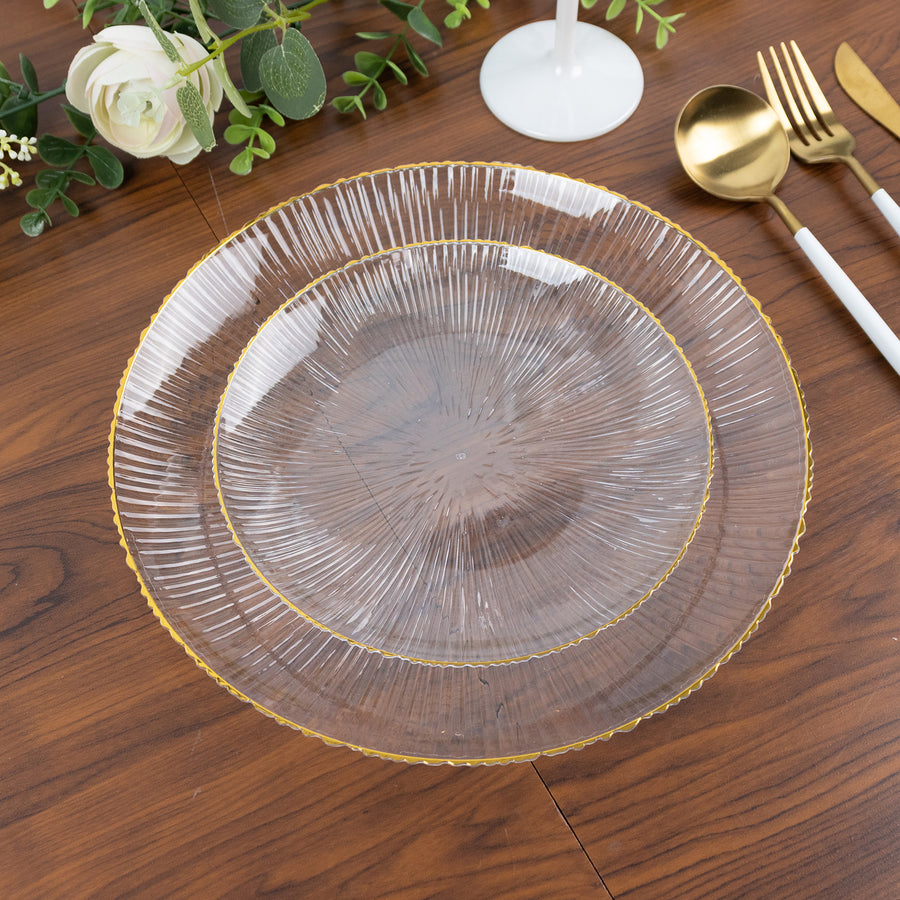 Clear decorative plate with gold trim on a wooden table setting.