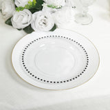 Elegant white plate with black beading and gold rim, surrounded by white roses.