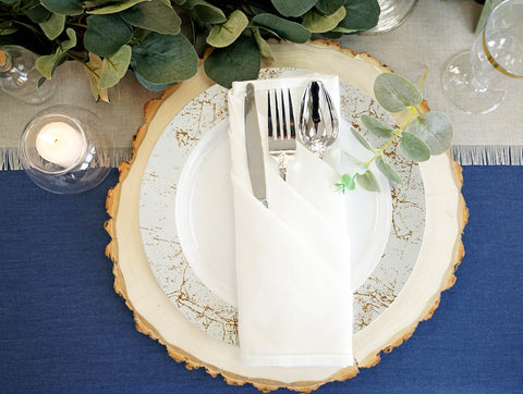 Silver charger plate with white plate and napkin