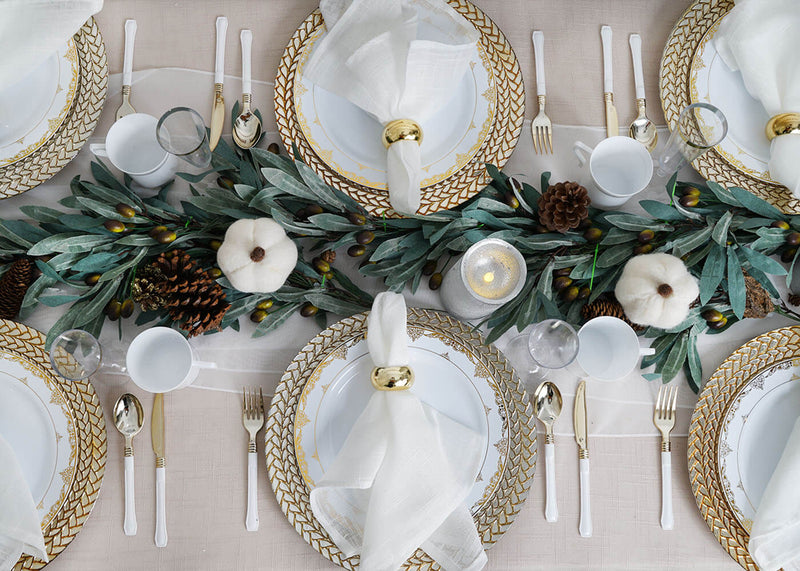 Overhead fall table setting with white plates and gold flatware