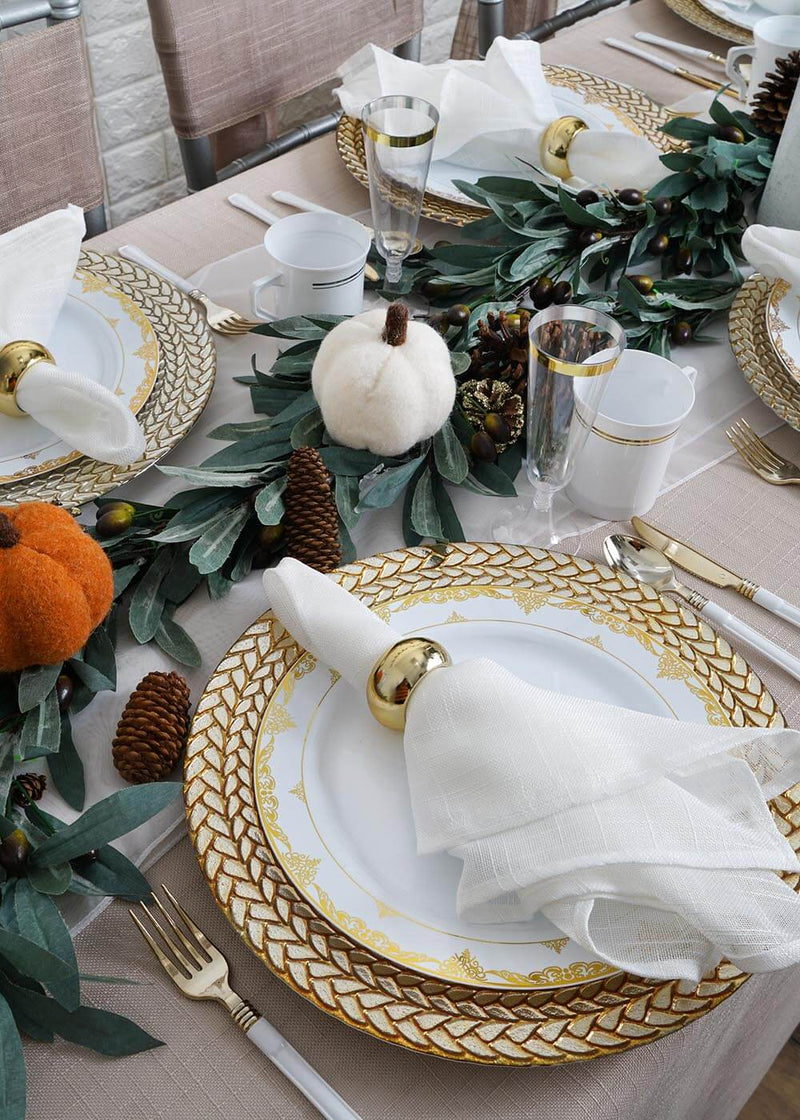 Close-up of a gold-rimmed place setting with white napkin