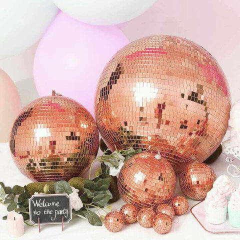 Rose-gold disco balls with party decor