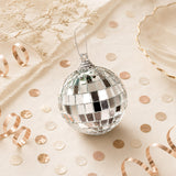 Mirrored disco ball ornament on beige holiday decor background