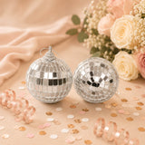 Silver mirrored disco ball ornaments with pastel floral wedding decor and confetti