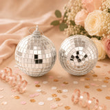 Silver disco ball Christmas ornaments with floral and confetti decor