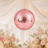 Pink disco ball wedding centerpiece with pastel flowers and candles