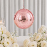 Pink mirrored disco ball centerpiece with white flowers and candles in elegant decor