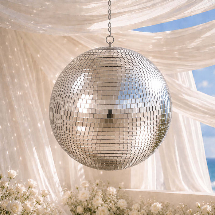 Hanging mirror disco ball under sheer drapes with white flowers and blue sky