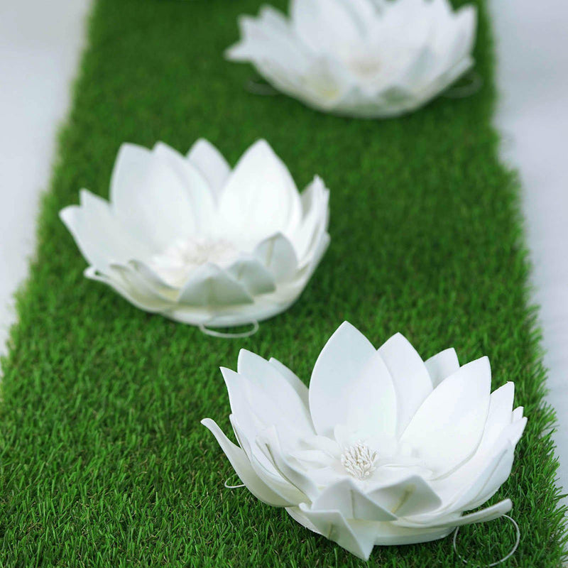 White lotus-shaped flowers on green grass