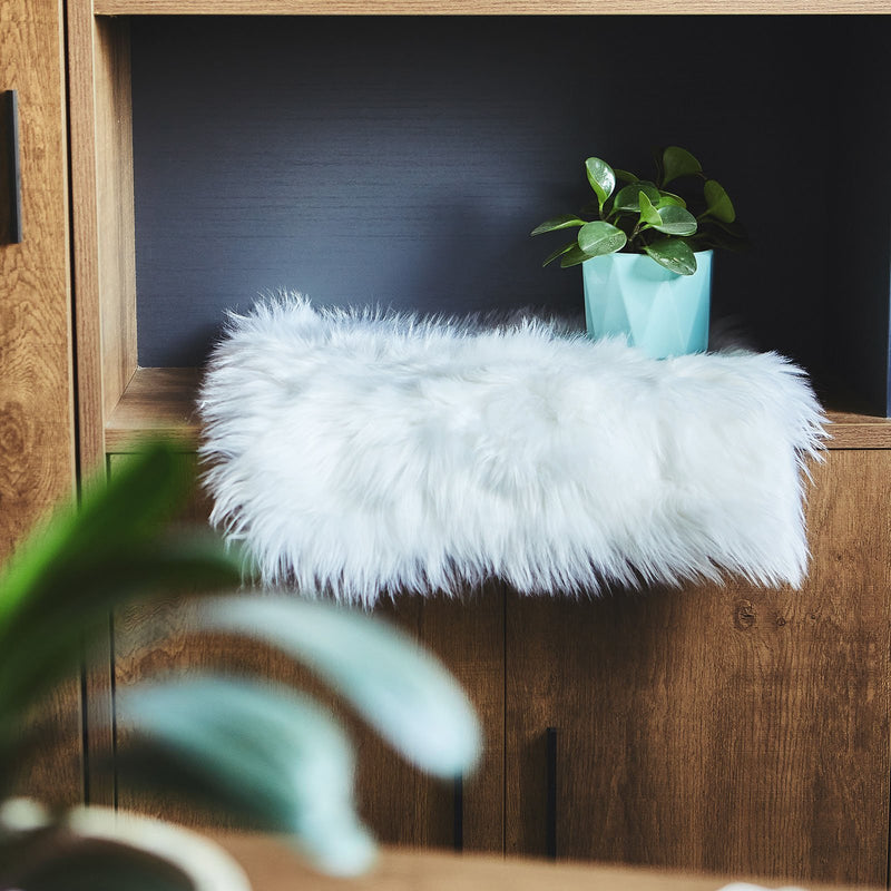 White sheepskin seat cushion on an ornate chair