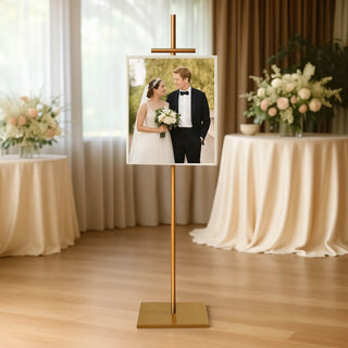 Elegant wedding photo display stand with framed picture, set in a stylish venue.
