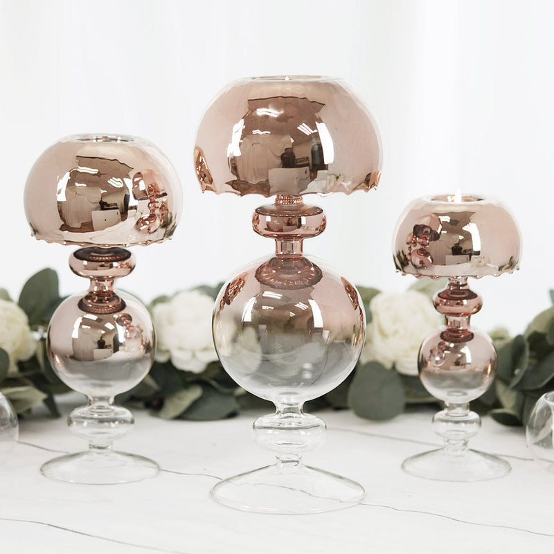 Three rose gold glass candleholders
