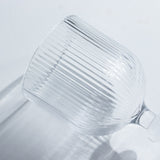 Ribbed glass wine goblet on a plain background